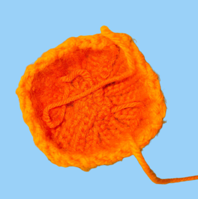 Shaping pumpkin with yarn needle