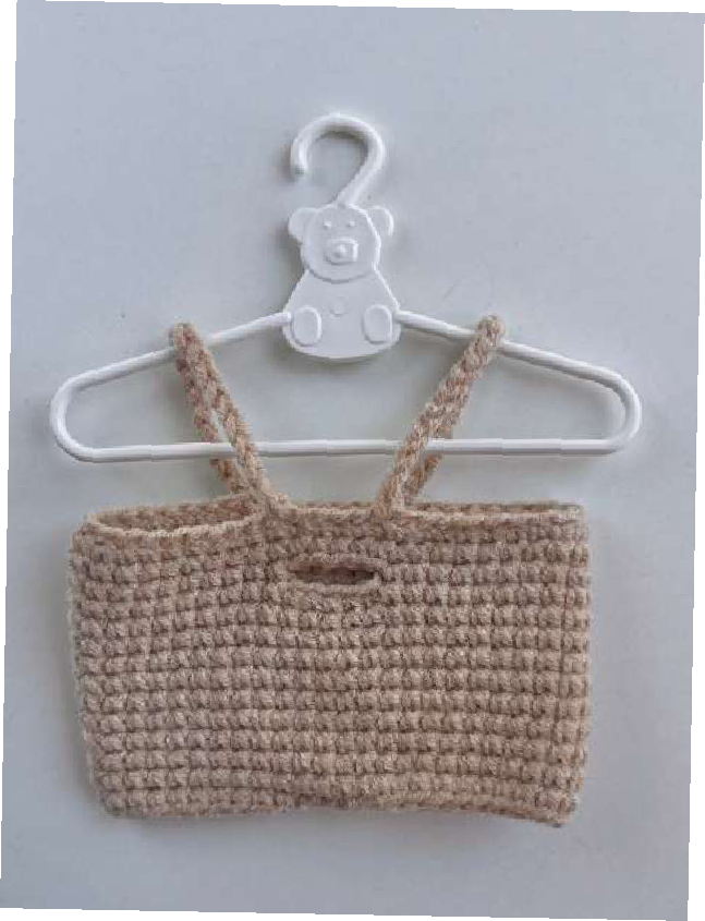 Crocheted overalls in progress, showing the main body