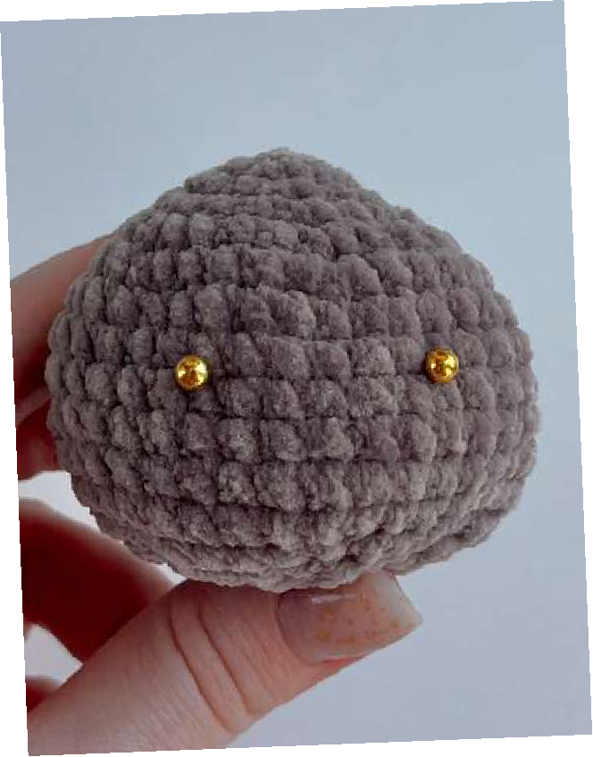 Close-up of bear head showing safety eye placement with stitch marker