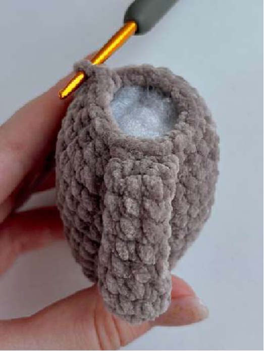 Crocheted bear body in progress, being stuffed