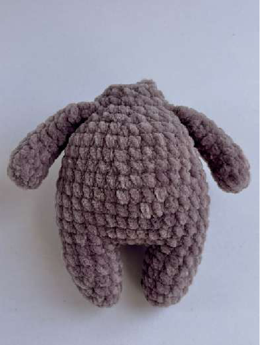 Finished crocheted bear body with arms attached, ready for head