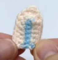 Finished eyebrows for the toy.