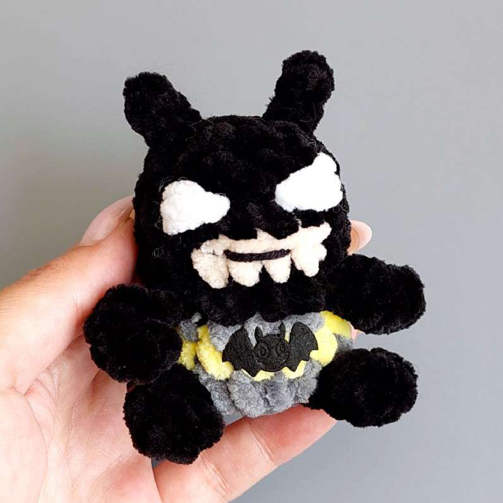 Crochet batman body with arms attached.