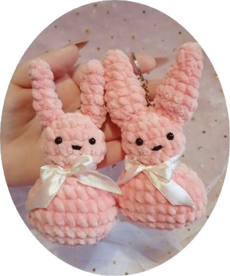 Finished crochet rabbit keychain with a pink bow.