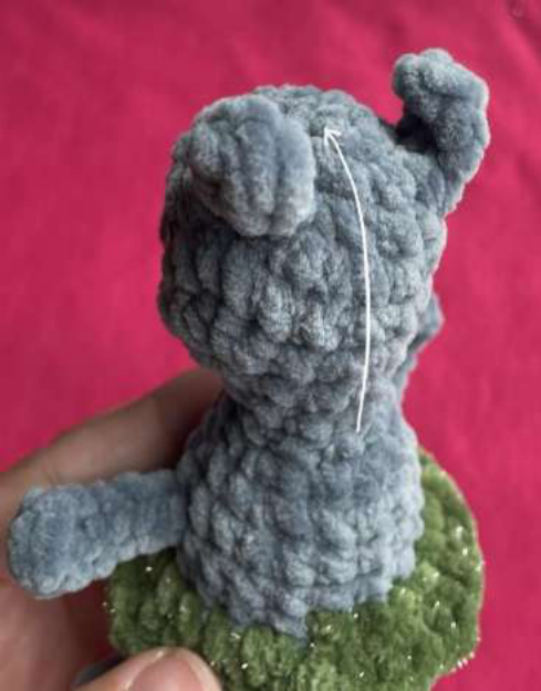 Attaching fur yarn to create the mane.