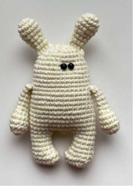 Close-up of a finished crocheted bear magnet face