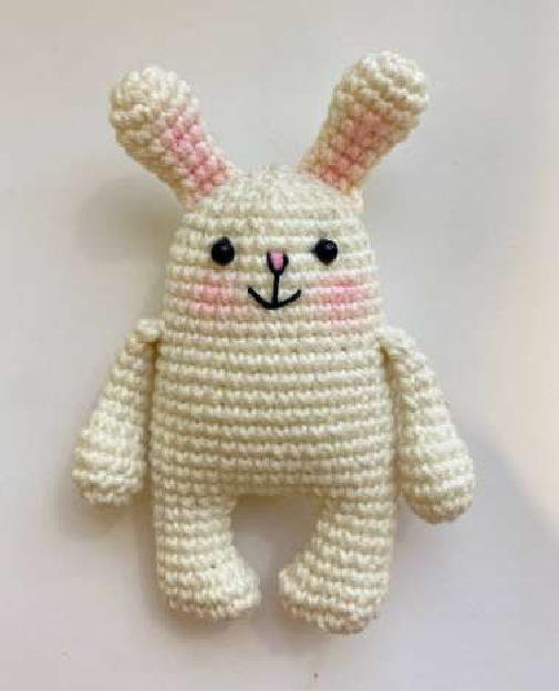Close-up of a finished crocheted bunny magnet face