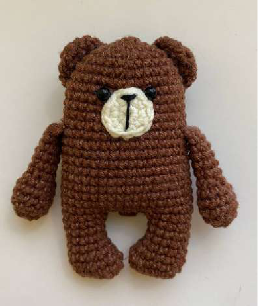 Close-up of a finished crocheted cat magnet face