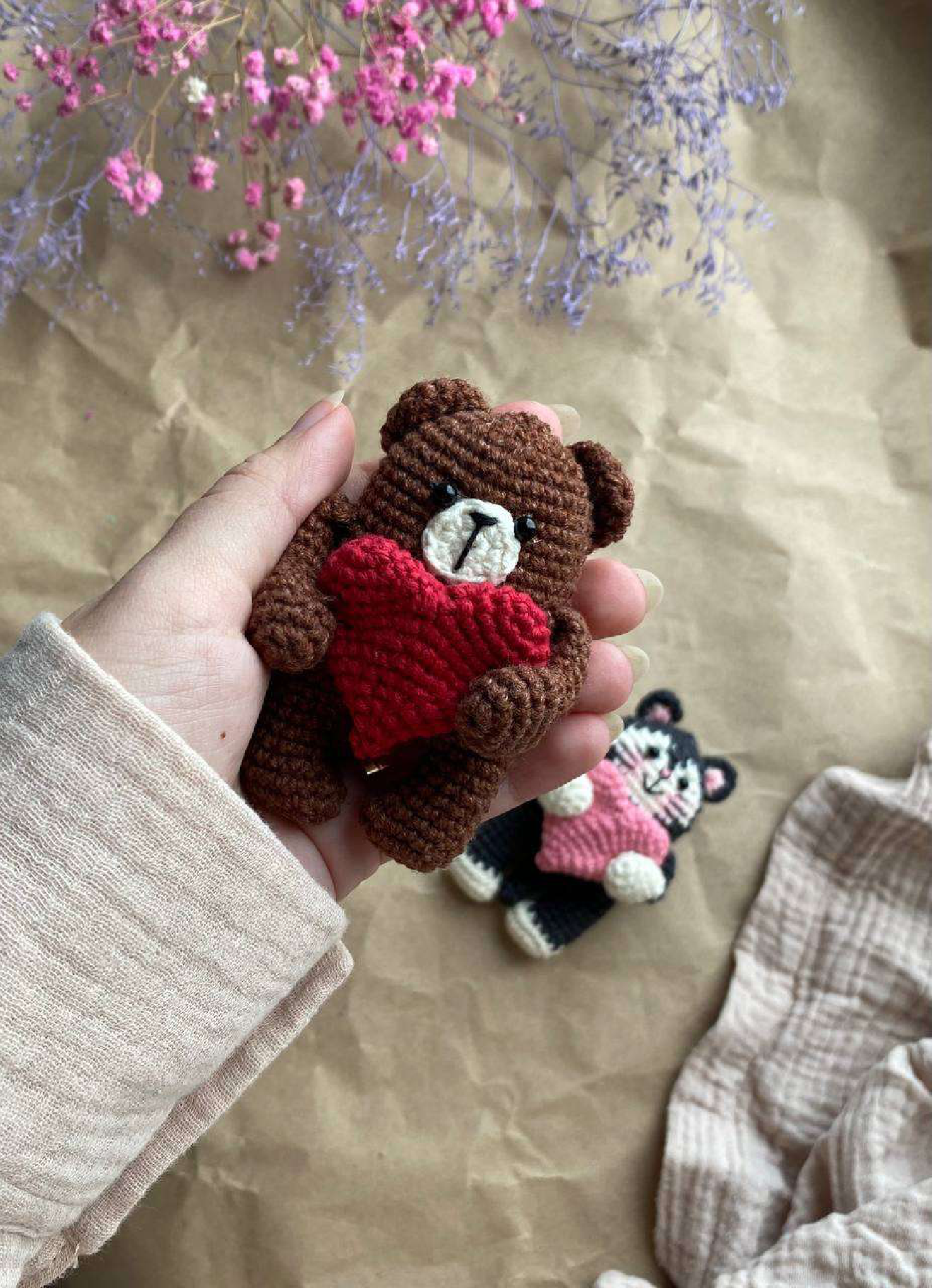 Crocheted brown bear magnet with red heart and black cat magnet in background