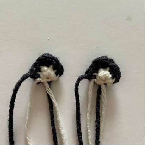 Close-up of crocheted cat ears with two-tone design
