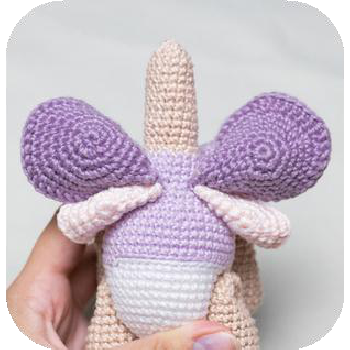 Positioning wing on doll's back