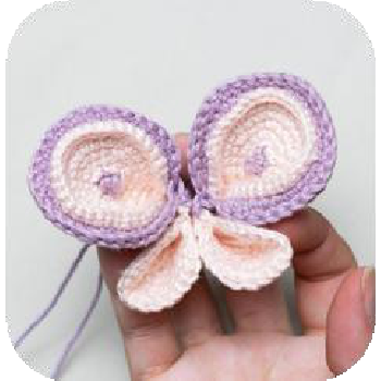 Sewing wing to doll's back