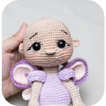 Yarn exiting top of doll head