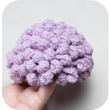 Crocheting hair strands on doll's wig cap