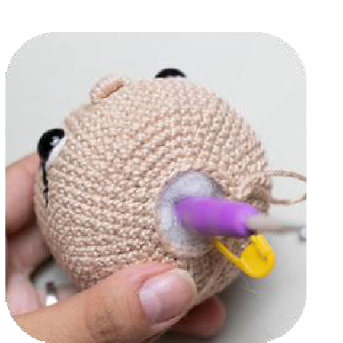 Inserting safety eyes into crochet head