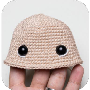 Embroidering eye whites on crochet doll