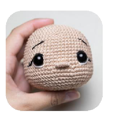 Embroidering lashes on crochet doll