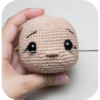 Embroidering eyebrows with black thread