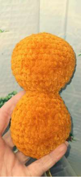 Attaching the plastic nose and eyes to the bear's face.