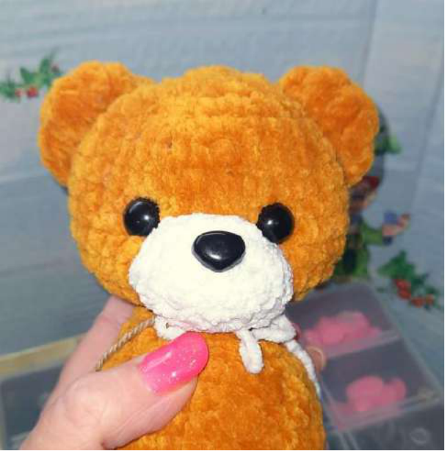 Two raspberry-colored top halves of the crochet heart.