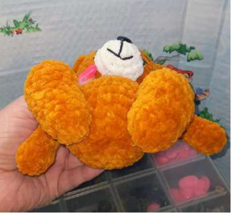 Sewing the white muzzle onto the bear's head.