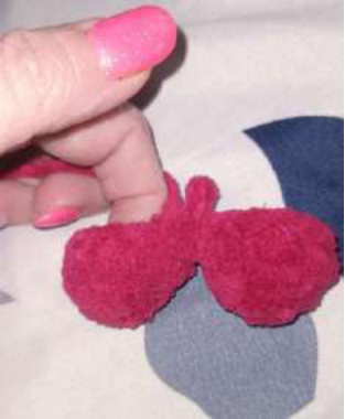 Stuffing the crochet heart with poly-fil.