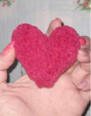 Tying a satin ribbon around the bear's neck.