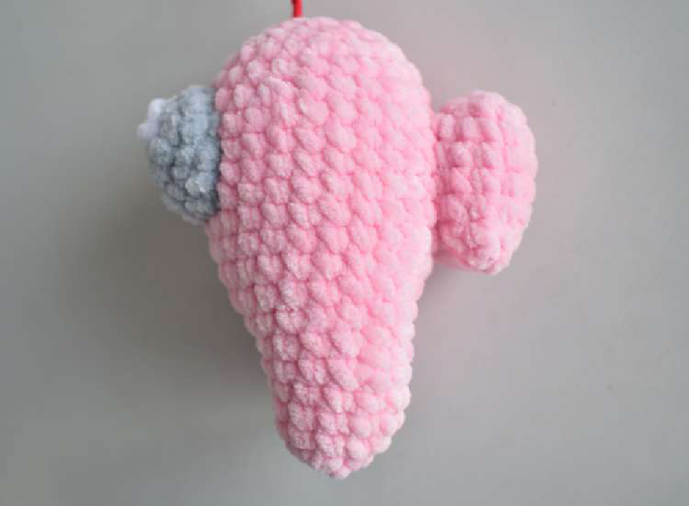 Assembling the cosmonaut by sewing on the porthole and backpack