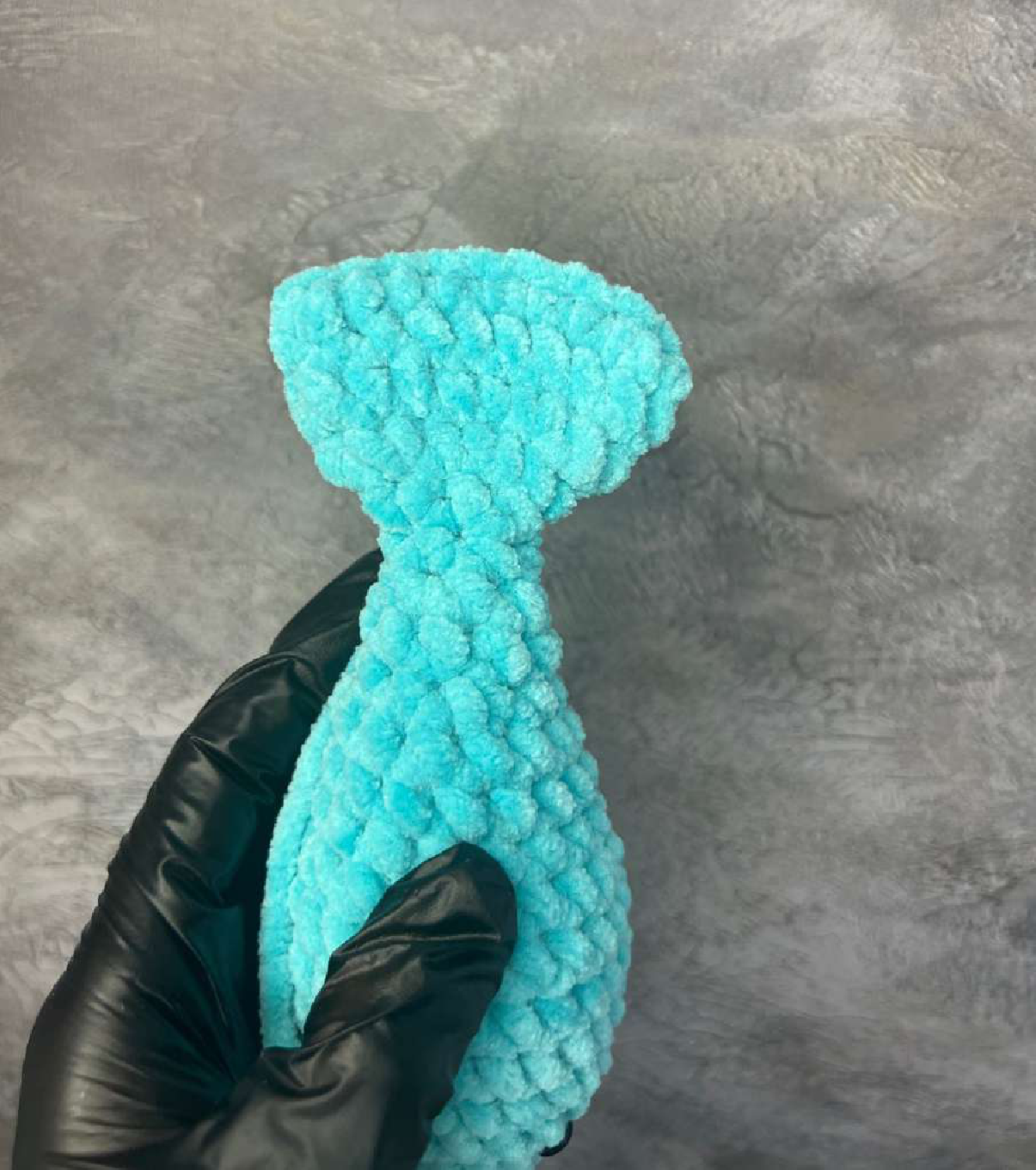 Crocheted dolphin body with solid tail starting to form
