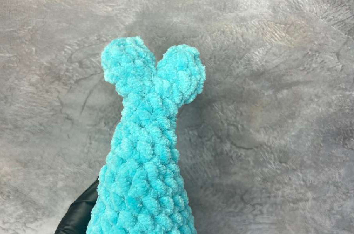 Crocheted dolphin body with split tail fin starting to form