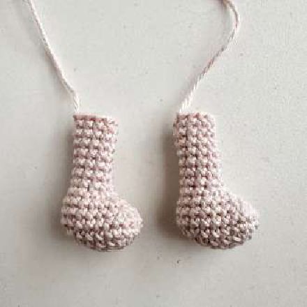 Two crocheted piglet leg parts