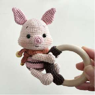 Side view of the assembled crocheted piglet rattle